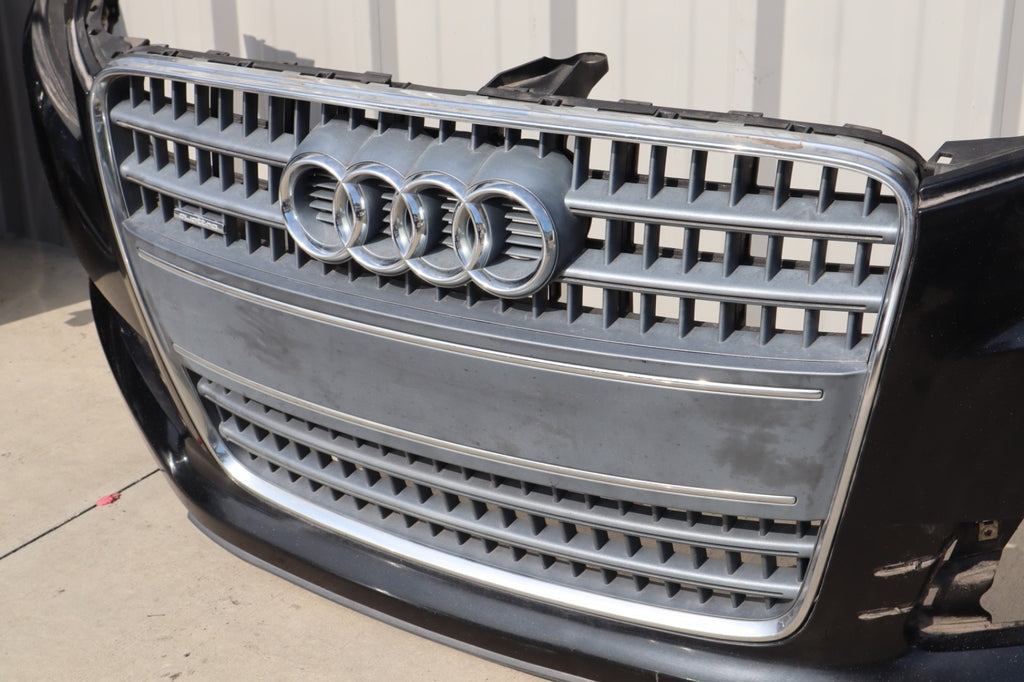 2007-2009 AUDI Q7 4L FRONT BUMPER COVER W/ GRILLE BADGE OEM